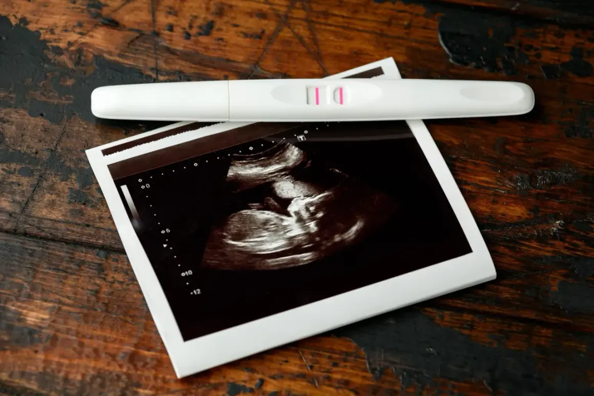 USG pokazuje, jak wygląda płód w 7 tygodniu ciąży. Obok leży pozytywny test ciążowy.